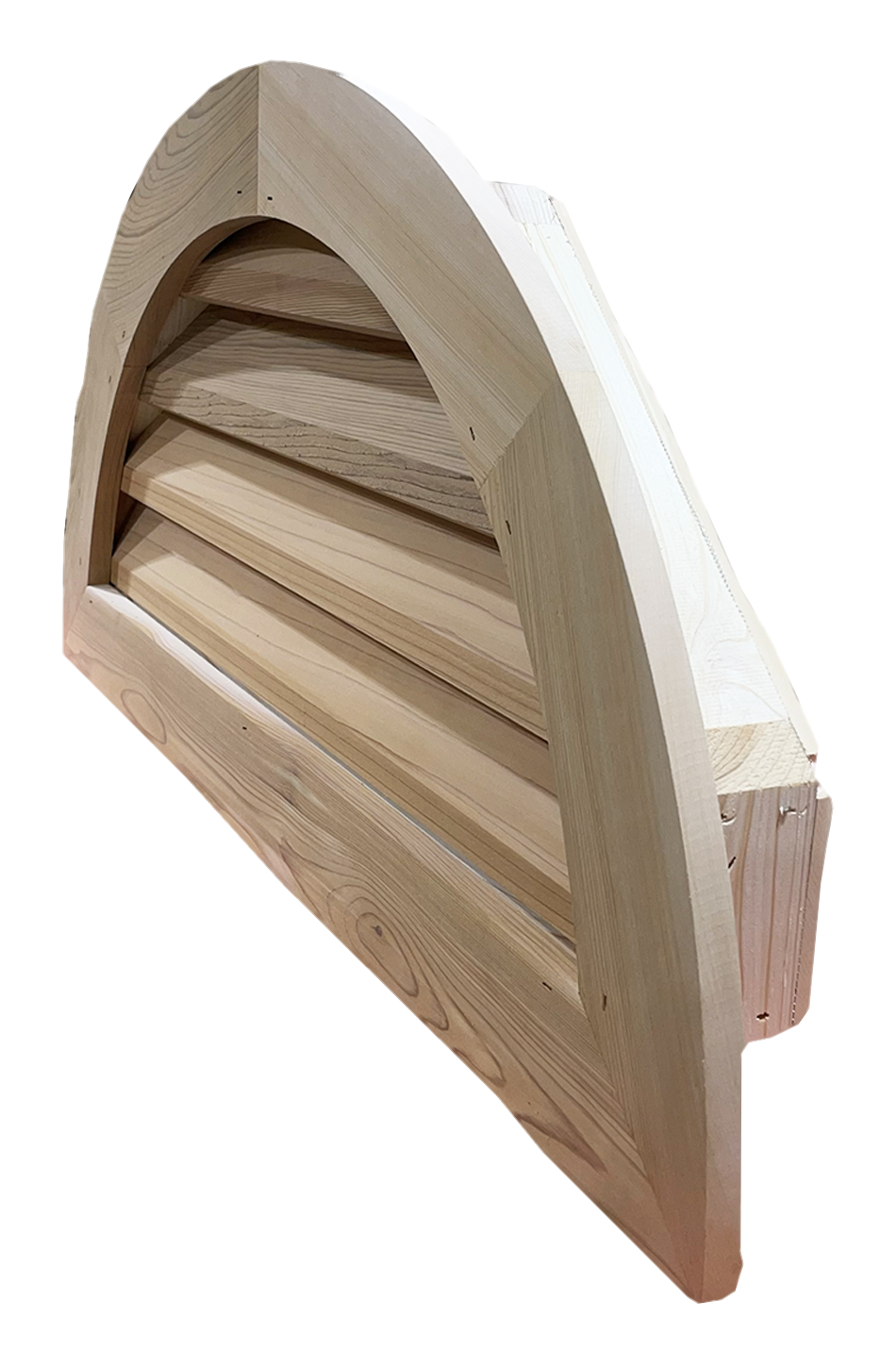 Rear angle of a cedar half-round gable vent, showing the jamb framing behind the louvers